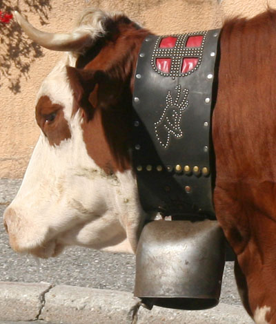 <Detailed French cow bell with the Croix de Savoie flag>