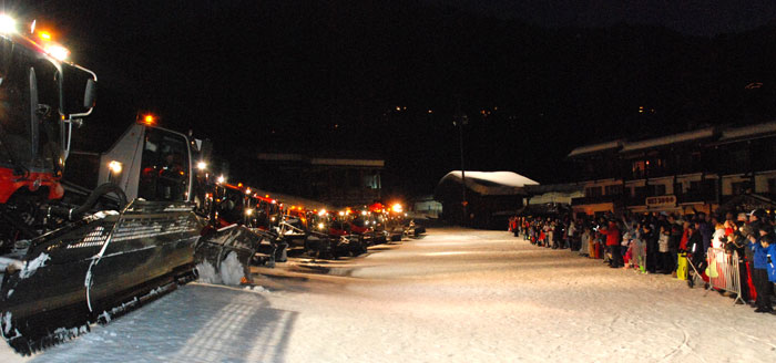 <Photo of a row of piste bashers/groomers/mogul munchers facing a crowd in La Clusaz, France>