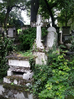 <Photo of plants overtaking graves at Pere Lachaise cemetery in Paris, France. >