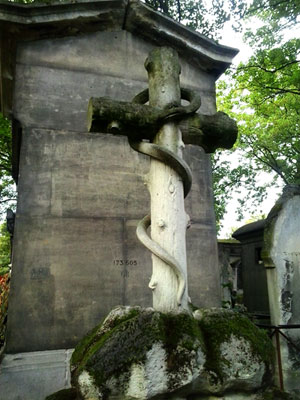 <Photo of a snake and cross grave at Pere Lachaise cemetery in Paris, France. >